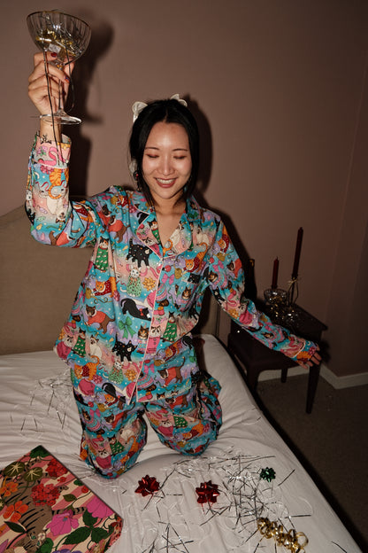 Cats' Christmas Morning rainbow pyjamas, celebrating