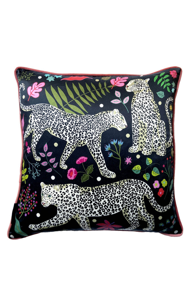 Karen Mabon silk cushion, with navy backdrop, featuring three snow leopards, leaves and flowers. Pink edges. 