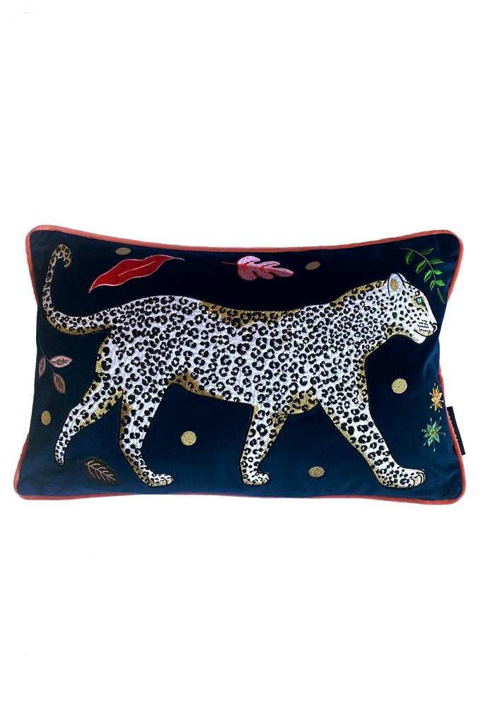 Leopard Bolster Cushion, navy blue velvet with white snow leopard embroidery surrounded by leaf motifs, edged with pink contrast velvet trim